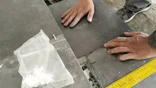 Laying tiles on a flight of stairs. Facing stairs with porcelain tiles.