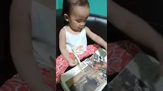 Sophia trying to read her favorite book 