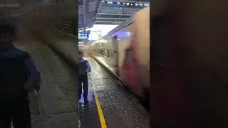 Train cruising through rain at Bandra
