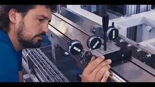 An employee is adjusting the alignment of several precision rails for an ongoing project