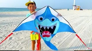 Fun family trip! Sofia and Max play with a kite on the beach