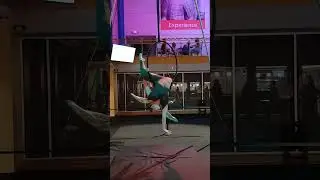 gymnastic girl twirling on circle suspended in the air