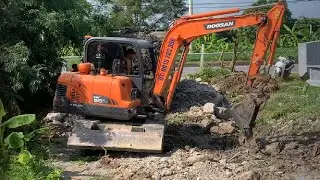 Excavator working on construction site - Operating a backhoe excavator
