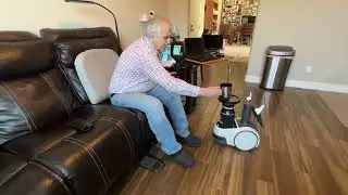 Astro Robot dispenses water at the couch