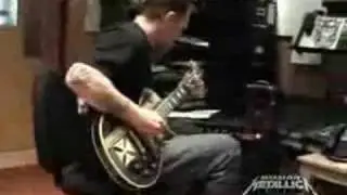 Robert Trujillo playing an acouistic guitar