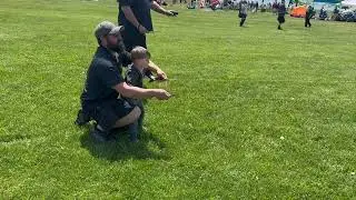 Josh teaching Harrison to fly a stunt kite