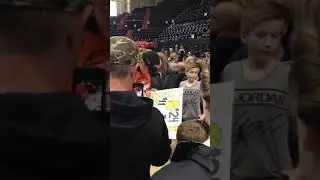Katie signs autographs with Hudson Whipple looking on