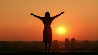 Stunning iStock Video | 4K Footage for Creative Projects A girl stand on roof during sunset/sunrice