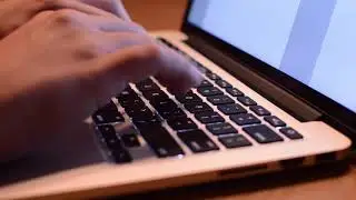 A person is typing on laptop