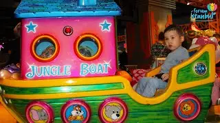 Two little children are riding on a childrens train in the park. Children activity for children.