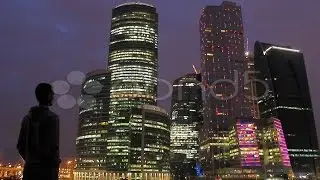 The Young Man And Sky-Scrapers Background At Night, Time Lapse. Stock Footage