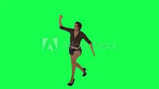 An angry woman in a brown dress and black shorts picks up a stone from the ground and throws it