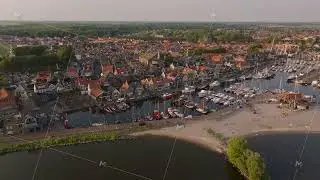 Charming dutch coastal town from above, showcasing a marina, waterfront, and picturesque