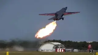 A legendary fighter jet spits out fire while taking off