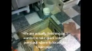 Snaking a grease trap drain using a drain auger