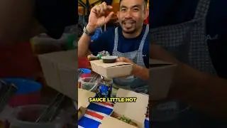 Friendly locals help tourists at food market, KL, Malaysia 