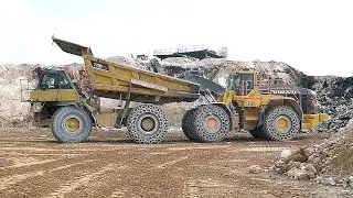 Volvo L350H Powers Through with a Cat 775D.Heavy Duty Rock Loading.