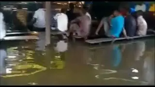 Football Fans Watch Their Favorite Team Play in a Flooded Viewing Centre in Nigeria