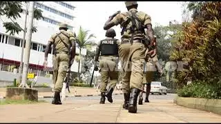 Age limit: Ssegirinya runs from police officers after being found vending red ribbons