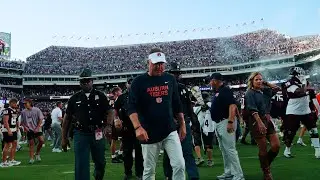 Auburn coach Hugh Freeze and players walk off Kyle Field after losing 16-10 to Texas A&M