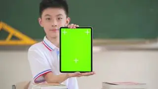 A boy showing 4k green screen tablet