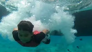little boy jumping from the boot
