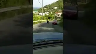 Man rides motorized wheelchair down the mountain in Virgin Islands.