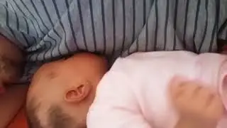 Hungry baby desperate for milk from Father