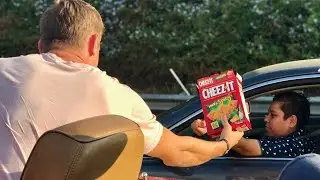 Feeding people Cheez-Its in traffic