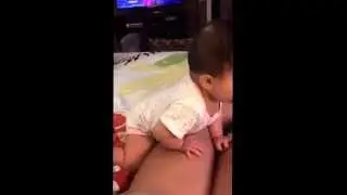 Zealyn standing at 8 months