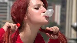 Cute Female Teen Redhead Blowing Bubblegum