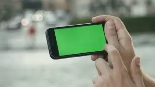 close up man holding smartphone touch screen with green screen chroma key for custom content