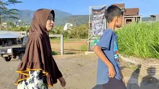Free footage | some people walking to the field with mountain and some plantation area