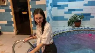 Busines lady plunged into the pool wearing glasses