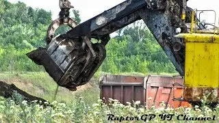 Old EKG-4.6 rope shovel loads dirt on KAMAZ-6520 trucks