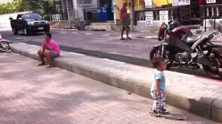 Tommy plays football with a friend.