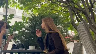 Two girls smoking cigarettes in short skirts, spitting and littering
