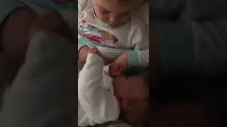 Big sister Lily tries to breastfeed little sister Elsie. “It’s not funny”.
