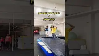 Our coach  teaching the kids on how to do frontflip.