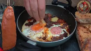Saganaki with spicy pastourma, eggs, fresh tomatoes, and melting cheese.