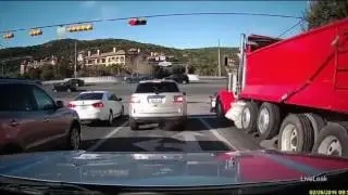 Dump truck barrels through red light, smashes cars