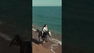 Pretty girl horse riding in Beach side 