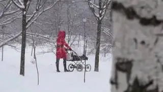 a Young Woman With a Pram in Winter in Slo-Mo