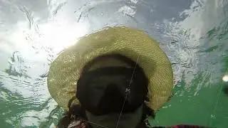 funny woman scuba diver swimming underwater in hat
