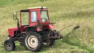 Tractor t 25 in a field | Home-made reaper or mower