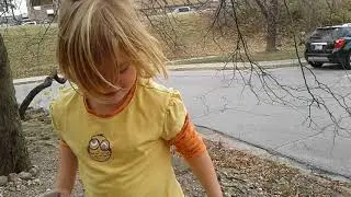 Ella throwing rocks into pond.