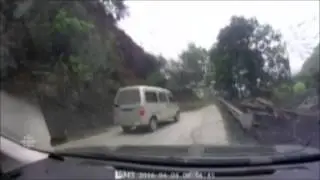 Huge landslide narrowly misses vehicle on road