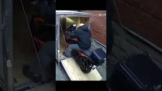 DUCK! DUCK AGAIN! Tucked both bikes into the trailer before the storm got here.