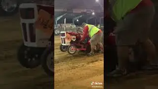 Mom cheering very loudly for her son that is Tractor pulling. Root beer money pulling team.