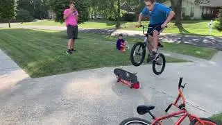 Large kid try’s to jump 2 skateboards on BMX. FAIL